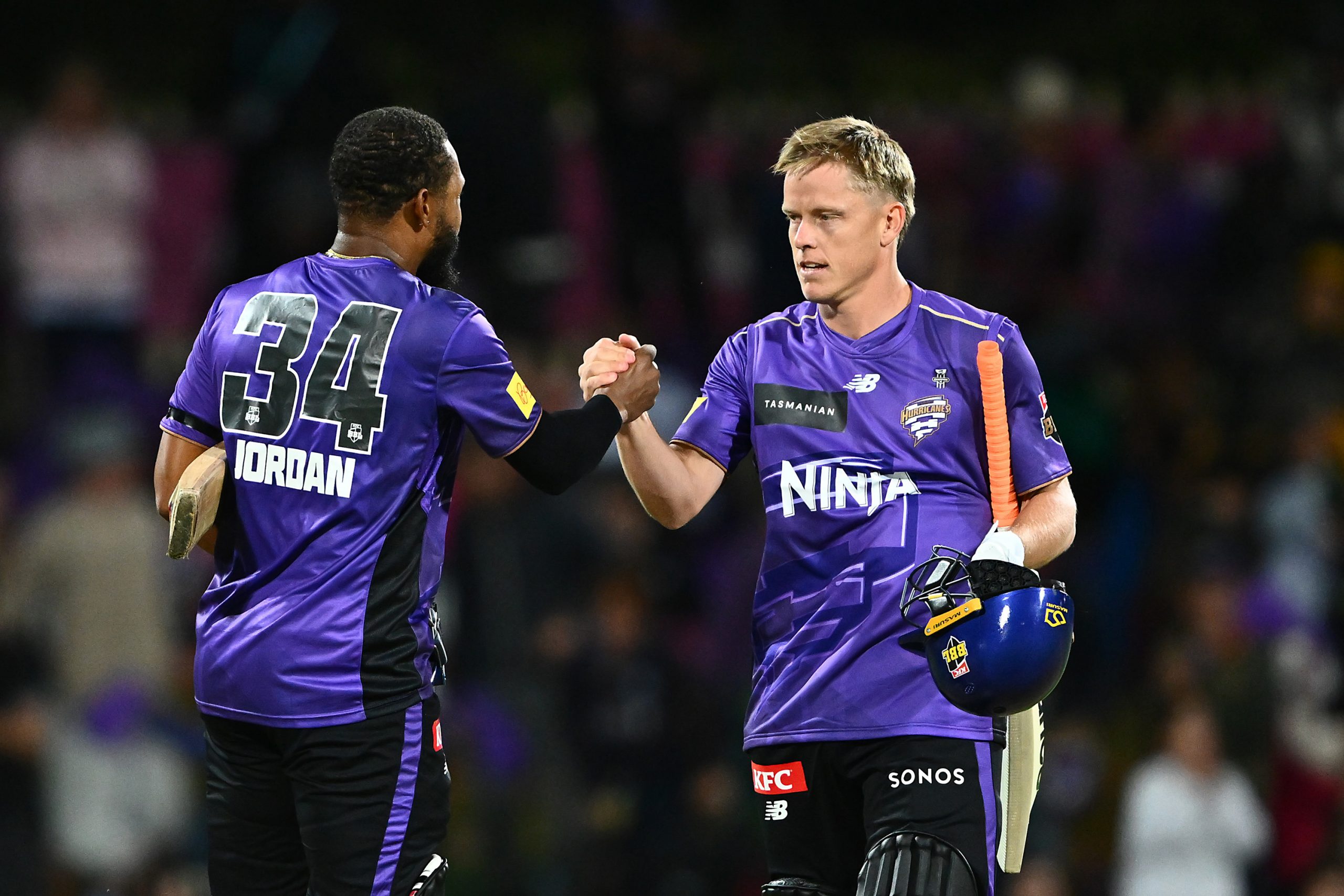 HOBART, AUSTRALIA - DECEMBER 16: Nathan Ellis and Chris Jordan of the Hurricanes celebrate the win during the BBL match between Hobart Hurricanes and Sydney Thunder at Ninja Stadium, on December 16, 2025, in Hobart, Australia (Photo by Steve Bell/Getty Images)