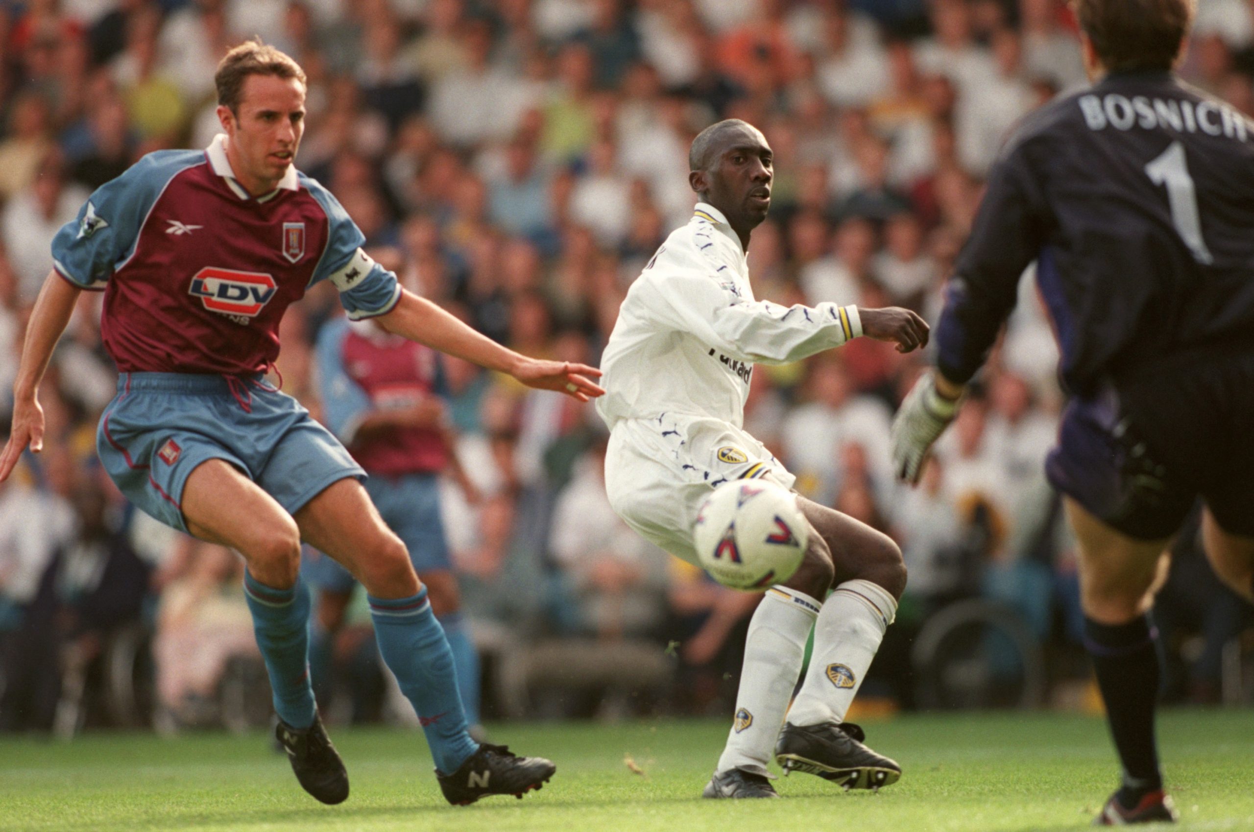 Aston Villa's Gareth Southgate (left) shepherds the ball back to goalkeeper Mark Bosnich.