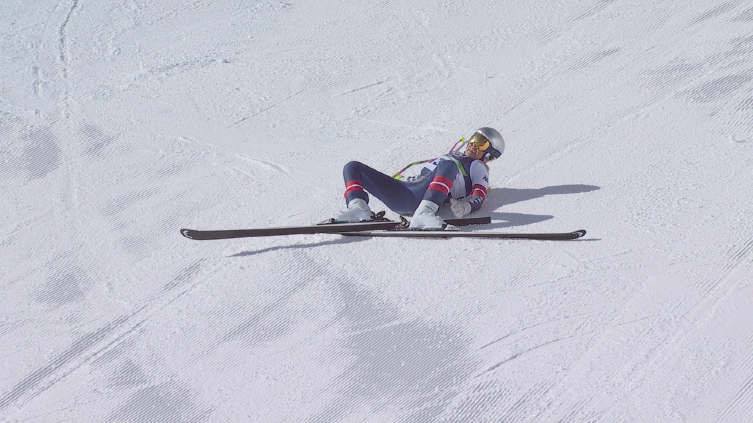 Lindsey Vonn lays on the snow after crashing in the downhill final.