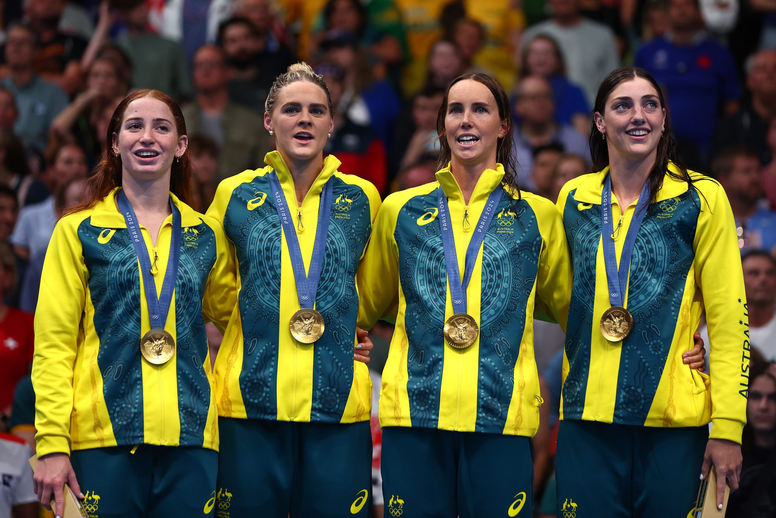 From left: Mollie O'Callaghan, Shayna Jack, Emma McKeon and Meg Harris pictured during the medal ceremony after winning 4x100m freestyle gold at the Paris Olympics.