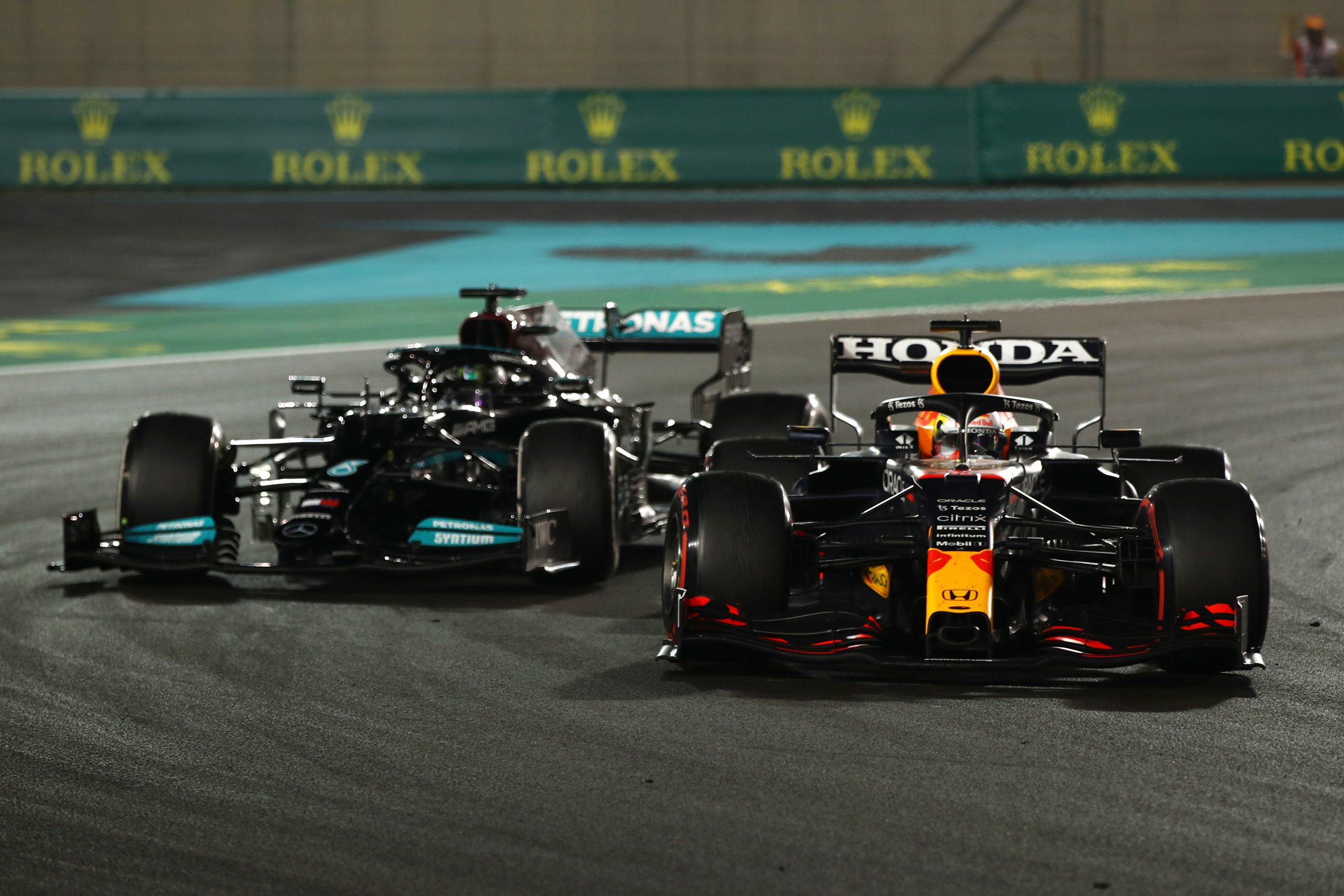 Max Verstappen of the Netherlands driving the (33) Red Bull Racing RB16B Honda leads Lewis Hamilton of Great Britain driving the (44) Mercedes AMG Petronas F1 Team Mercedes W12 during the F1 Grand Prix of Abu Dhabi at Yas Marina Circuit on December 12, 2021 in Abu Dhabi, United Arab Emirates. (Photo by Joe Portlock - Formula 1/Formula 1 via Getty Images)