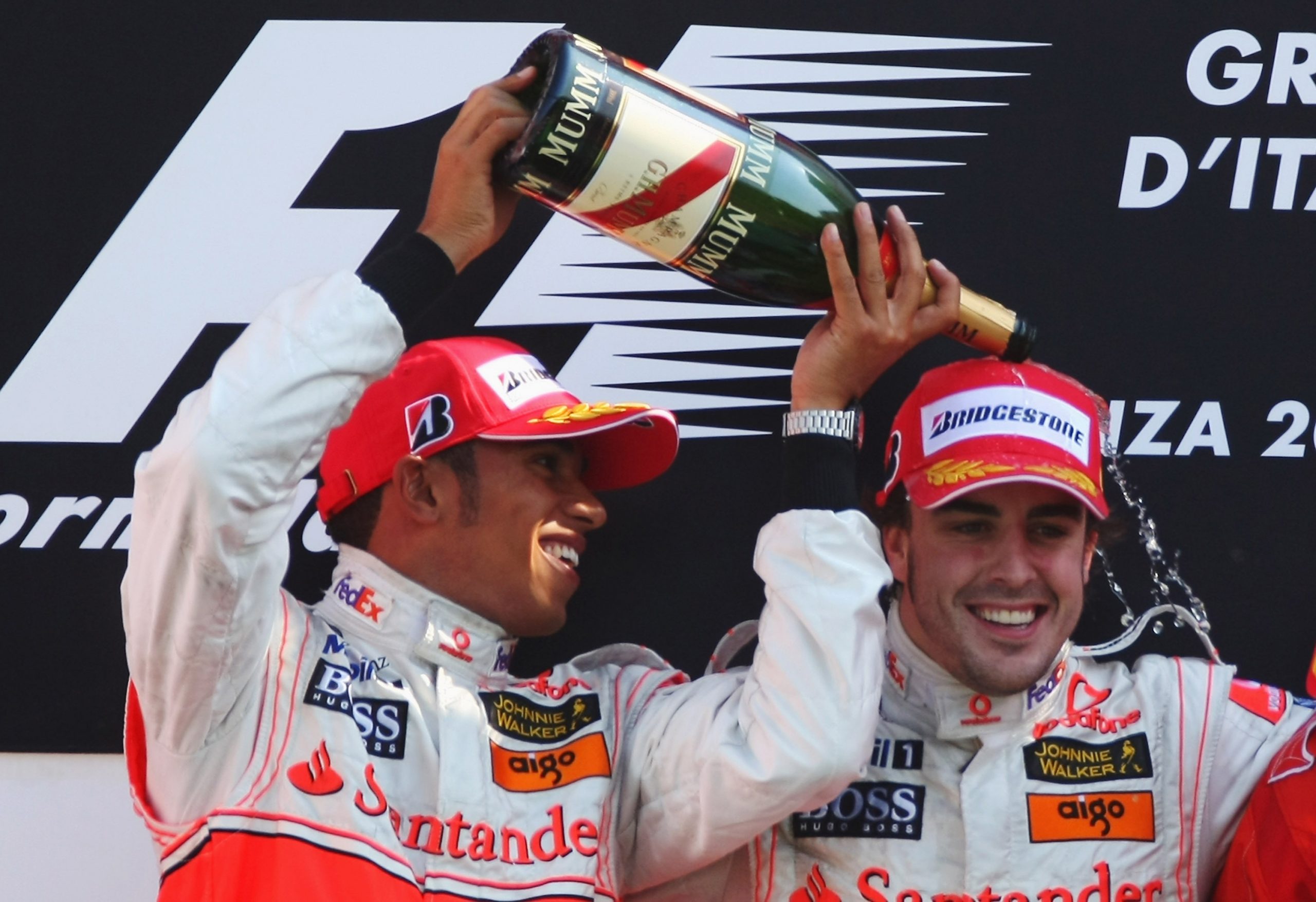 Second placed Lewis Hamilton of Great Britain and McLaren Mercedes and race winner Fernando Alonso of Spain and McLaren Mercedes celebrate on the podium after the Italian Formula One Grand Prix at the Autodromo Nazionale di Monza on September 9, 2007 in Monza, Italy.  (Photo by Clive Mason/Getty Images)
