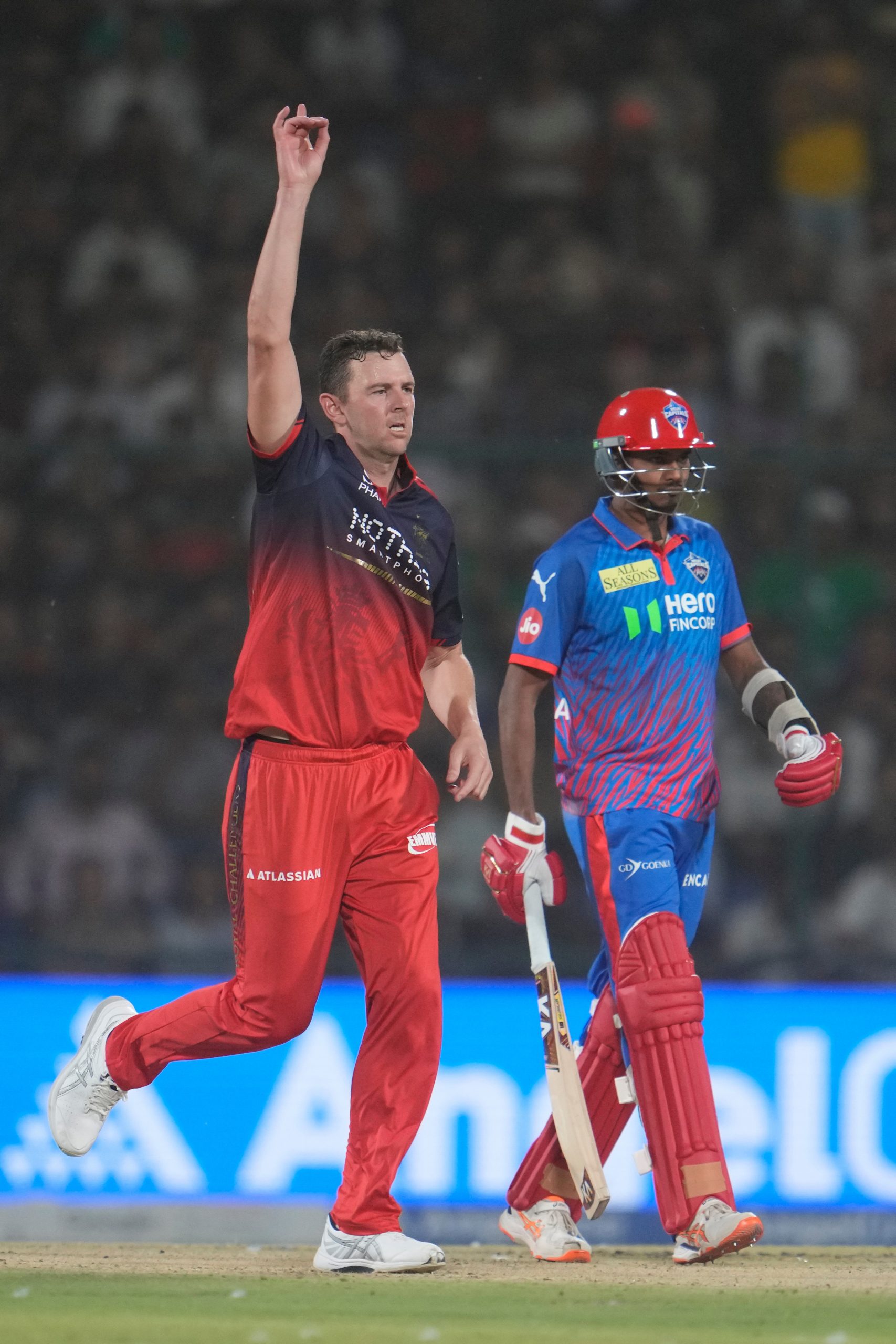 Josh Hazlewood, left, celebrates the wicket of Delhi Capitals' Abishek Porel.