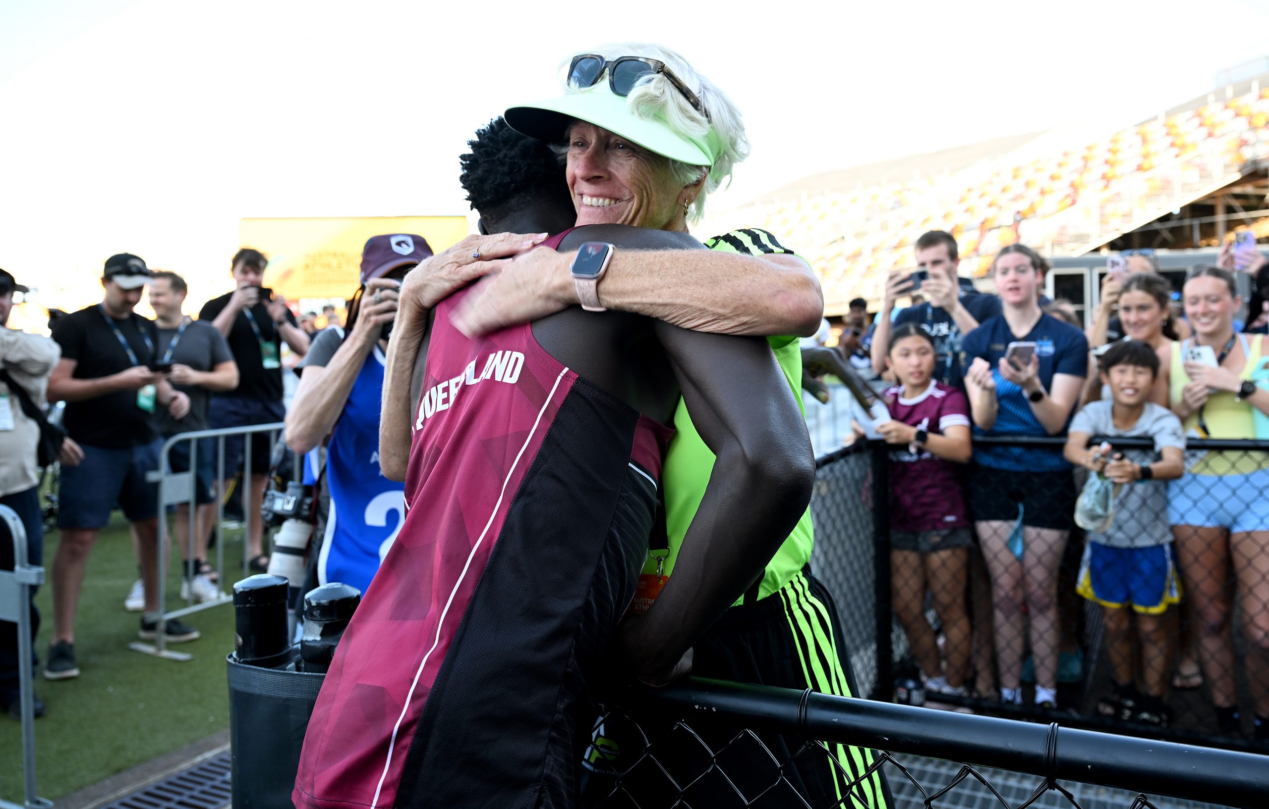 BRISBANE, AUSTRALIA - APRIL 18: Gout Gout embraces his coach Di Sheppard after winning the final of the Men's U20's 100m event during the 2026 Australian Athletics Junior Championships at Queensland Sport and Athletics Centre on April 18, 2026 in Brisbane, Australia. (Photo by Bradley Kanaris/Getty Images)